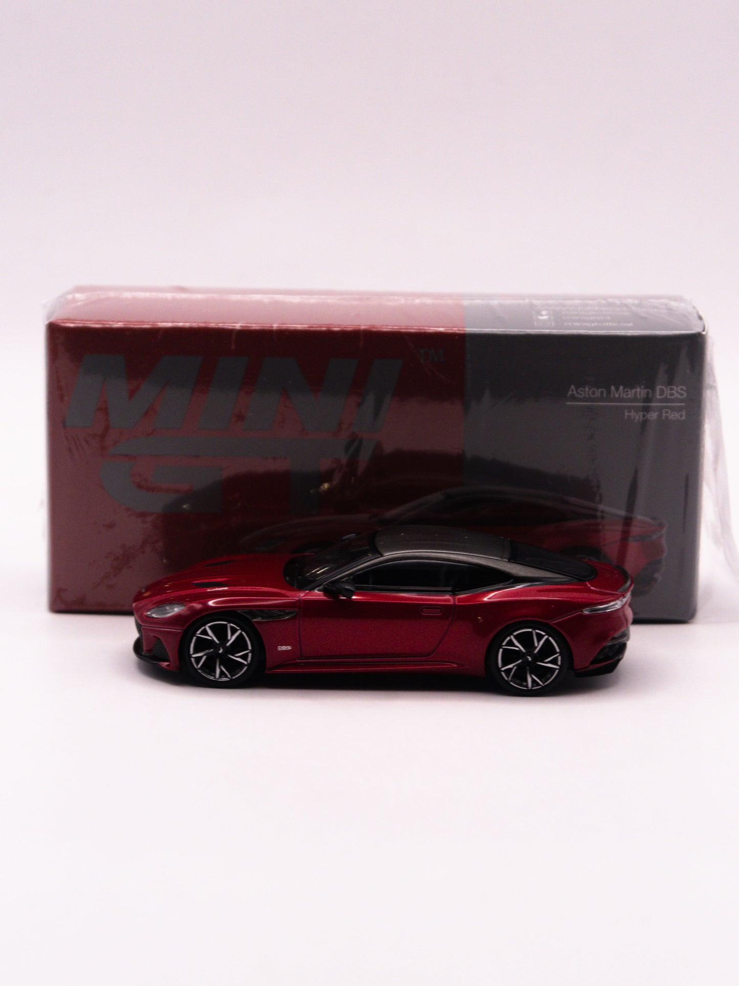 Mini GT #1065 Aston Martin DBS Hyper Red Czerwony
